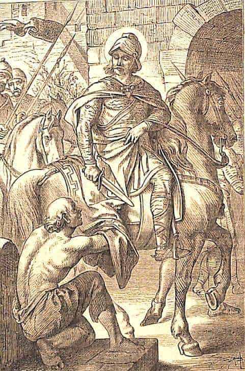 Der heilige Martin sitzt auf einem Pferd in voller Soldatenkleidung, er schneidet einen Teil seines Umhanges ab und gibt diesen dem Bettler.