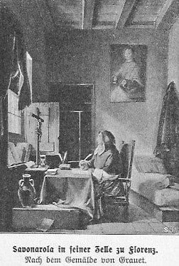 Savonarola in seiner Zelle in Florenz: er sitzt an einem Schreibtisch und schaut auf das Kruzifix, das vor ihm auf dem Tisch steht.